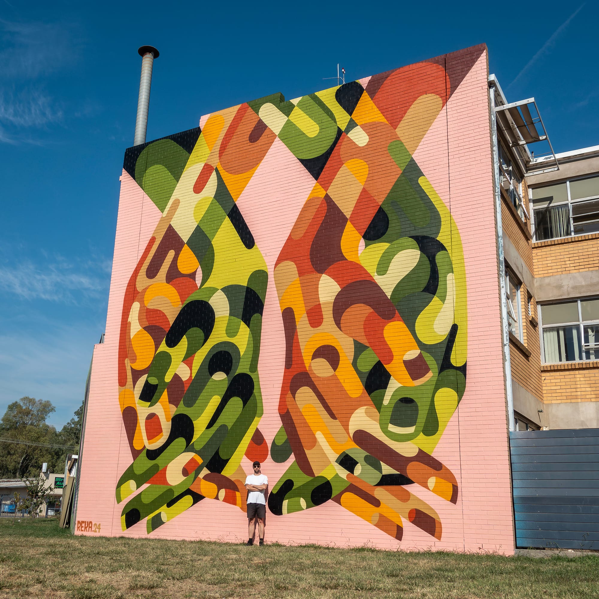 a vibrant abstracted mural of hands by James Reka
