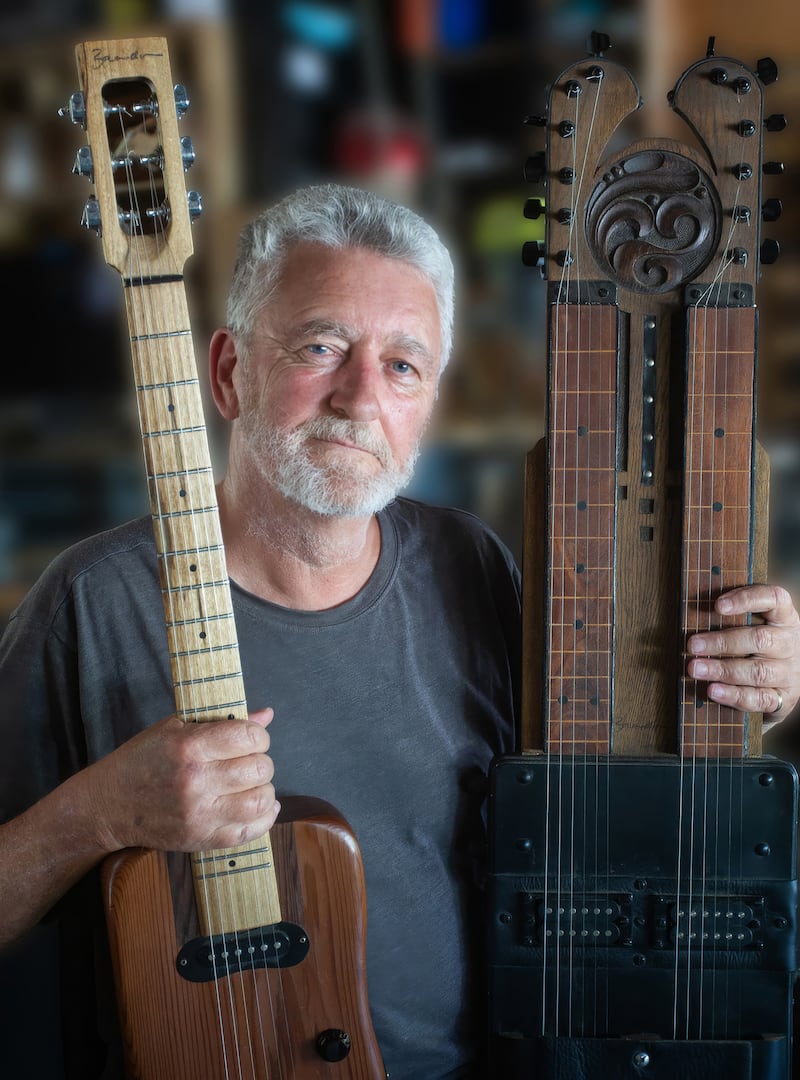 Garry Brandon with the guitars he makes with his son Josef