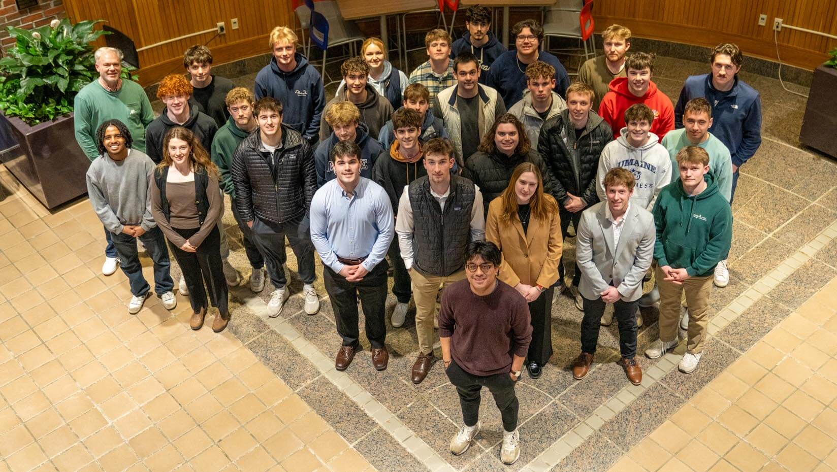 A group photo of SPIFFY members in the atrium of D.P. Corbett Business Building