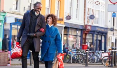 Mature black couple enjoying shopping together in UK high street