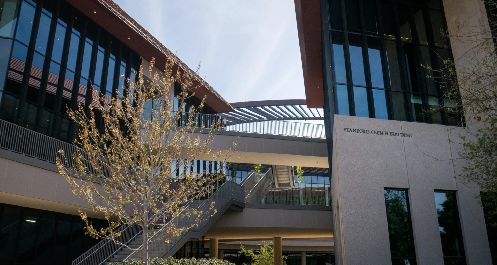 The exterior of the Chem-H building at Stanford with a tree in front.
