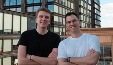 Trace founders Tim Cherkasov and Artur Romanov stand on a rooftop, crossing their arms