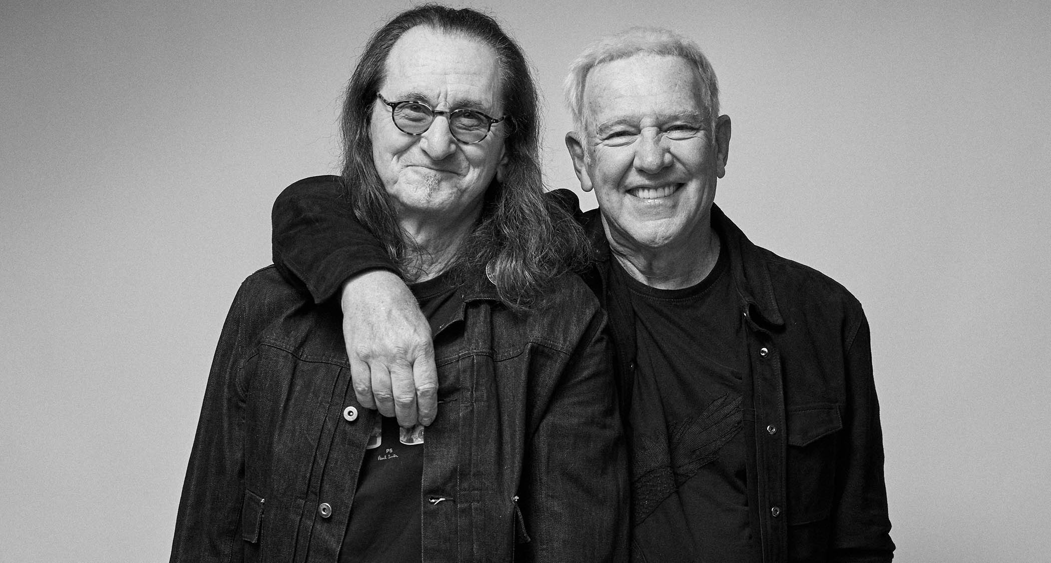 A black-and-white portrait of Rush's Geddy Lee [left] and Alex Lifeson as they announce their reunion tour.
