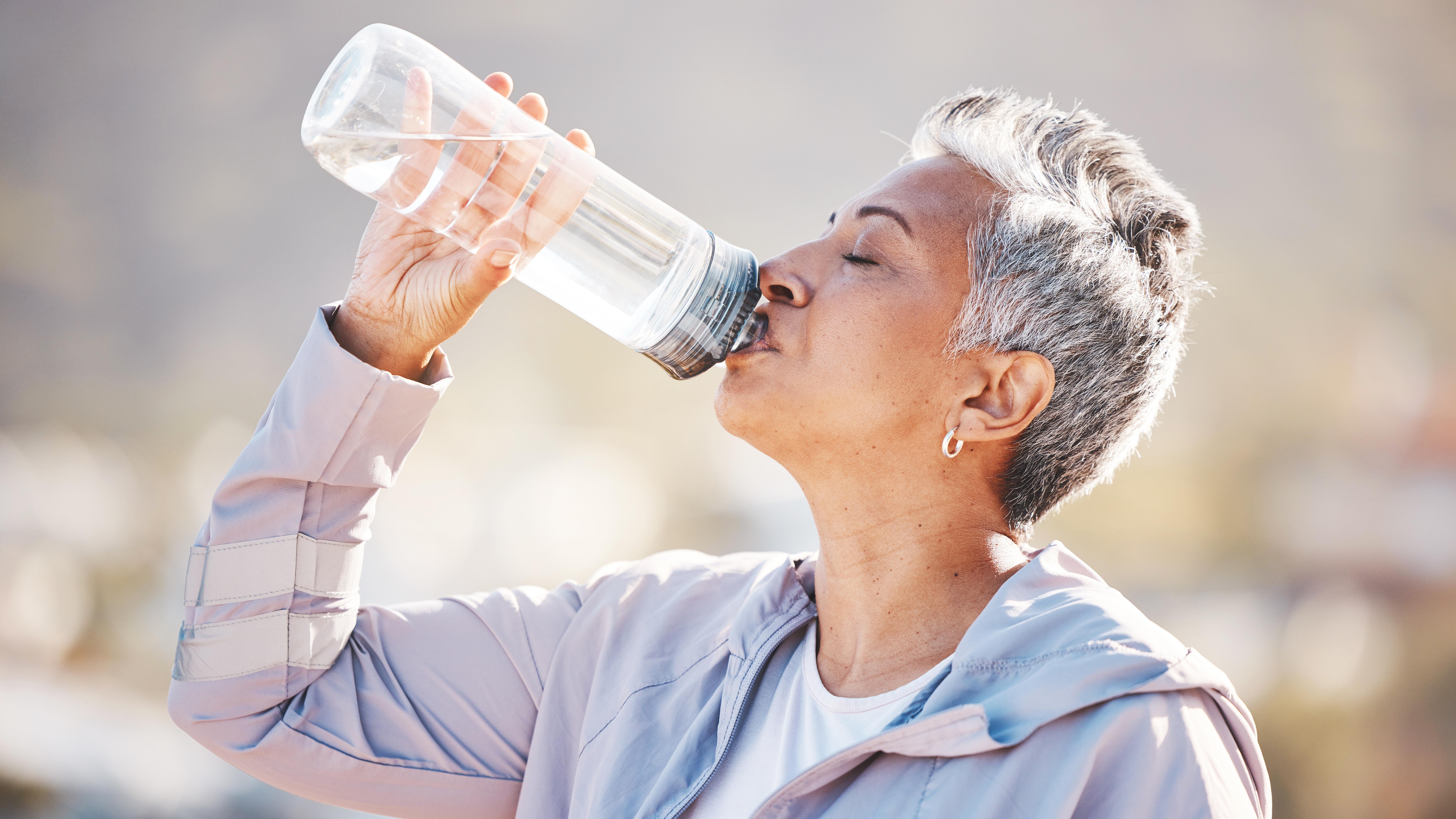 a senior woman drinking water