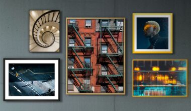 A collage of five framed photos on a gray wall, featuring a spiral staircase, a red brick building with fire escapes, a person with blond hair in dramatic lighting, a city street scene, and reflections of lights in water.