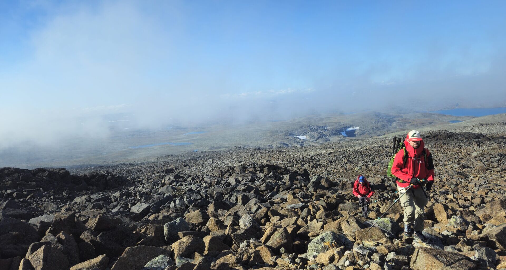 A member of Stealthcase climbing up to the peak of Mount Halti to test connectivity enabled by his red jacket