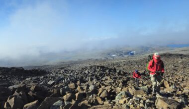 A member of Stealthcase climbing up to the peak of Mount Halti to test connectivity enabled by his red jacket