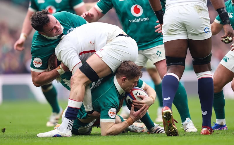 Henry Pollock of England tackles Ireland’s Garry Ringrose in Saturday's game. Photograph: Billy Stickland/INPHO