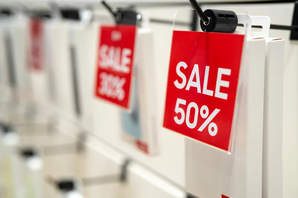 Sale signage on display, featuring discounts up to 50%, in a retail store setting