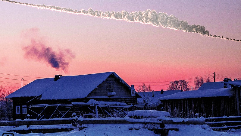 photo showing a streak of asteroid debris in the sky over a farmhouse with snow on its roof