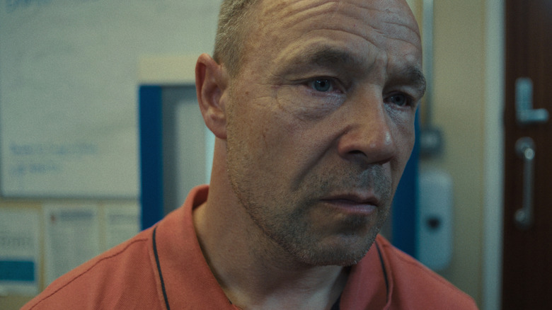 Eddie stares ahead, lost in thought, in 