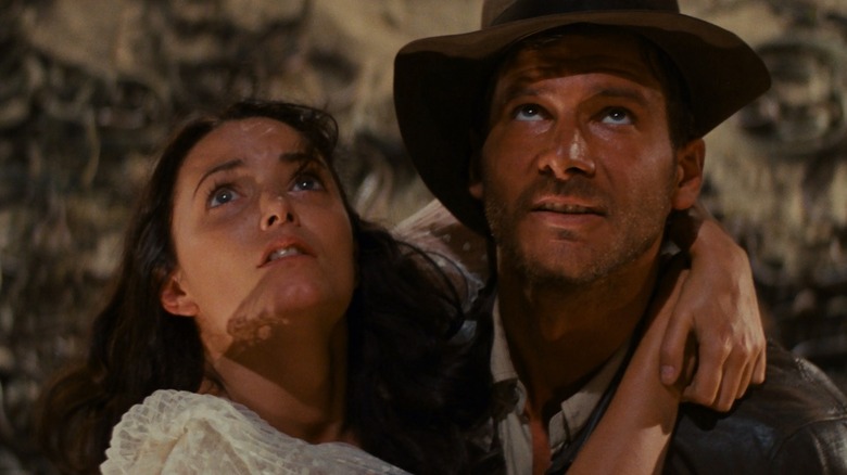 Karen Allen and Harrison Ford as Marion Ravenwood and Indiana Jones embracing in a snake pit in Raiders of the Lost Ark