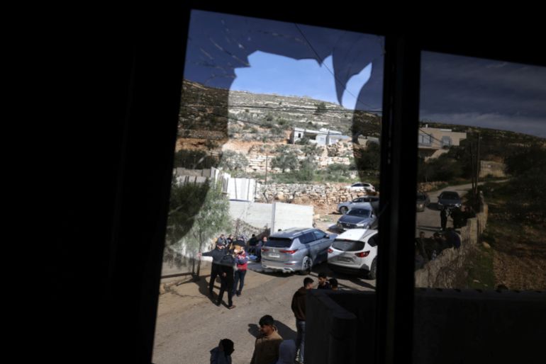 A shattered window overlooks a street after it was broken when Jewish settlers vandalised vehicles and homes in the Palestinian village of Telfit, south of the Israeli-occupied West Bank city of Nablus on February 13, 2026.