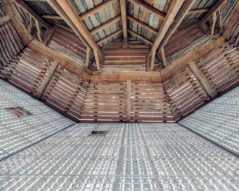 alexandre de betak inserts reflective light installation into traditional swiss barn