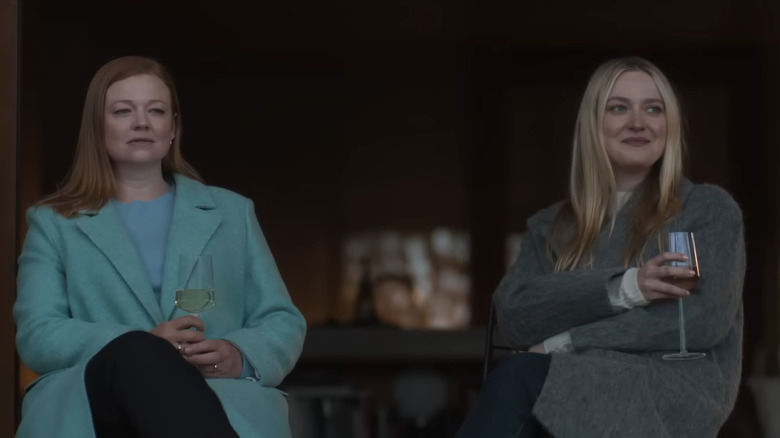 Sarah Snook as Marissa Irvine and Dakota Fanning as Jenny Kaminski sitting together drinking in All Her Fault