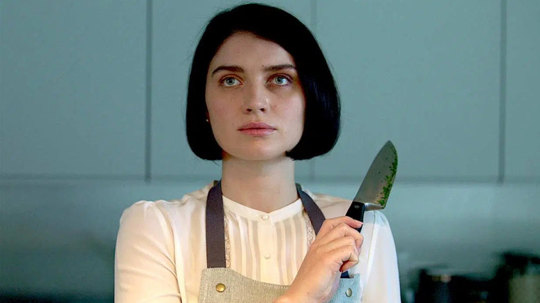 Eve Hewson as Adele Ferguson, holding a kitchen knife in Behind Her Eyes