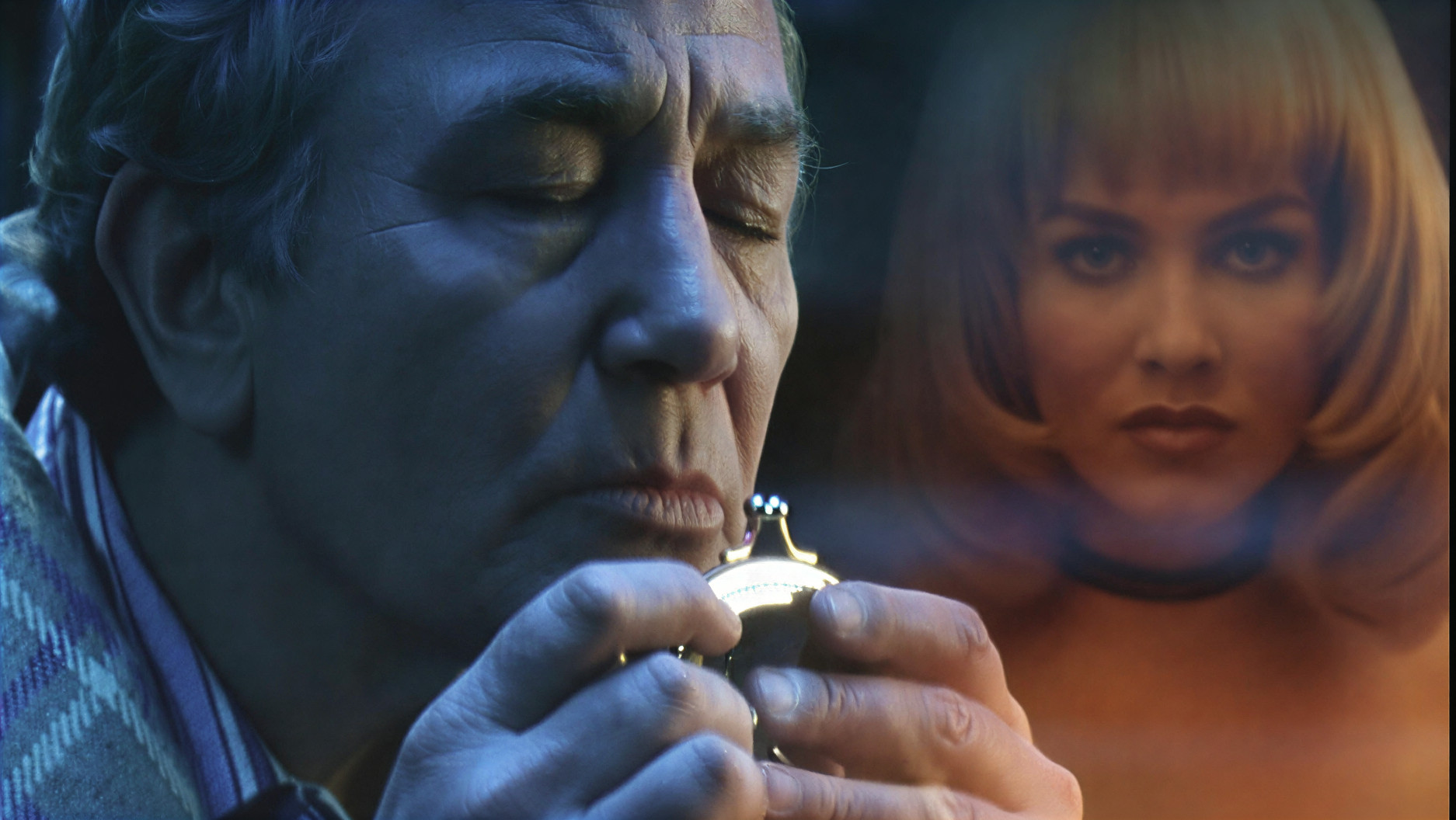 A man thinking while the face of a woman is in the background.