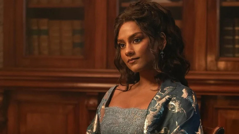 Kate Bridgerton (Simone Ashley) stands in her nightgown in a library in Bridgerton