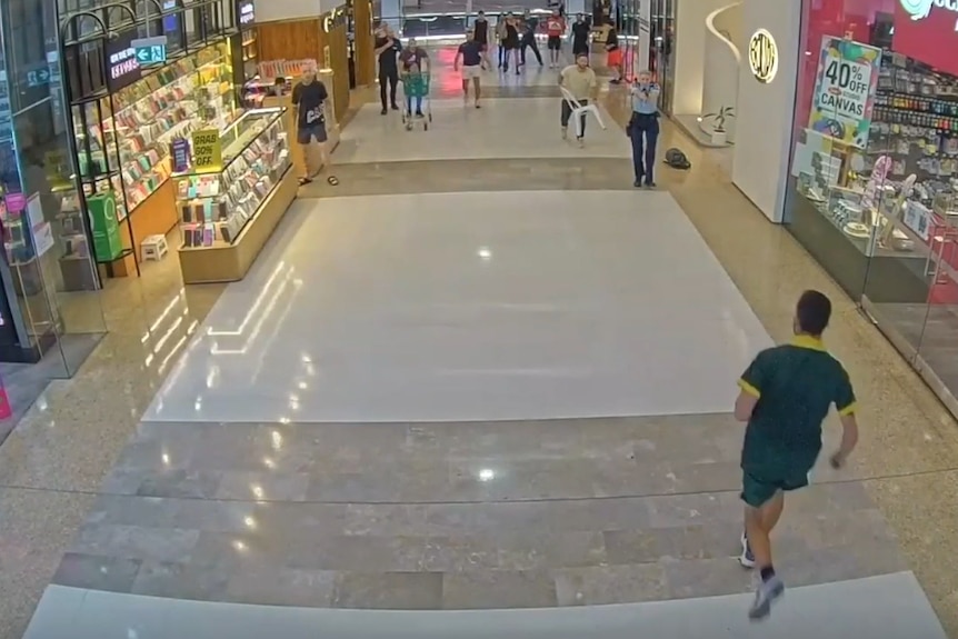 Footage of Cauchi running towards Amy Scott who is holding a gun