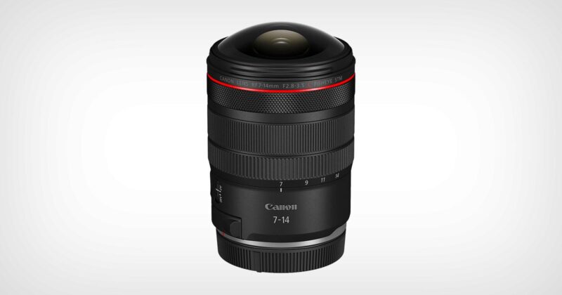 A Canon RF 7-14mm camera lens with a wide, rounded glass front element, black body, red ring near the top, and white text displaying focal length and brand, against a plain light background.