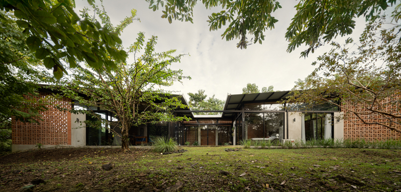 a series of porous brick partitions enclose central garden within costa rica residence