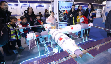 Visitors looking at a model of the Tianggong Space Station. Credit - CGTN / VCG