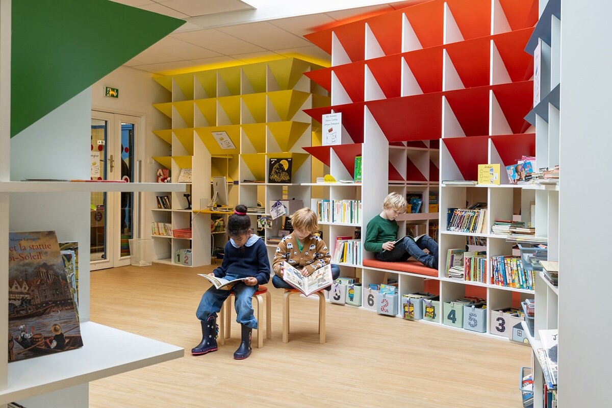 children enjoy reading village of colorful huts at paris school library