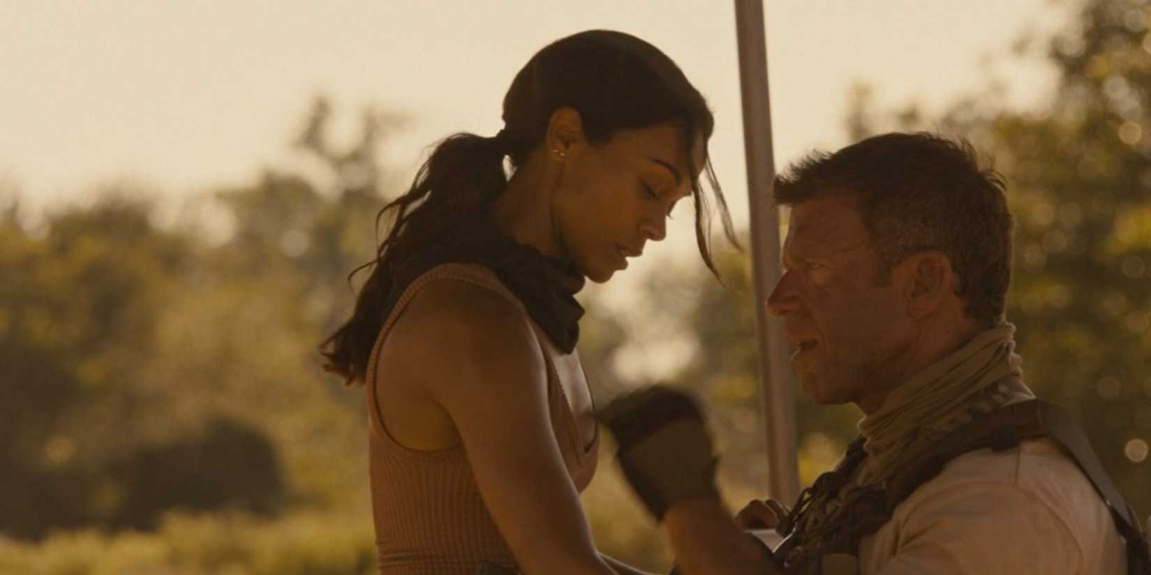 Joe (Zoe Saldana) and Cody (Taylor Sheridan) under a tent in Lioness season 2, episode 1