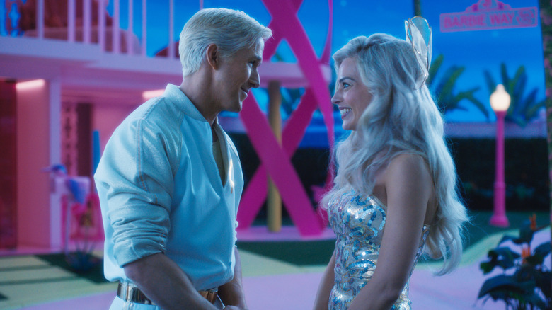 Ryan Gosling and Margot Robbie as Ken and Barbie facing each other at night in Barbie
