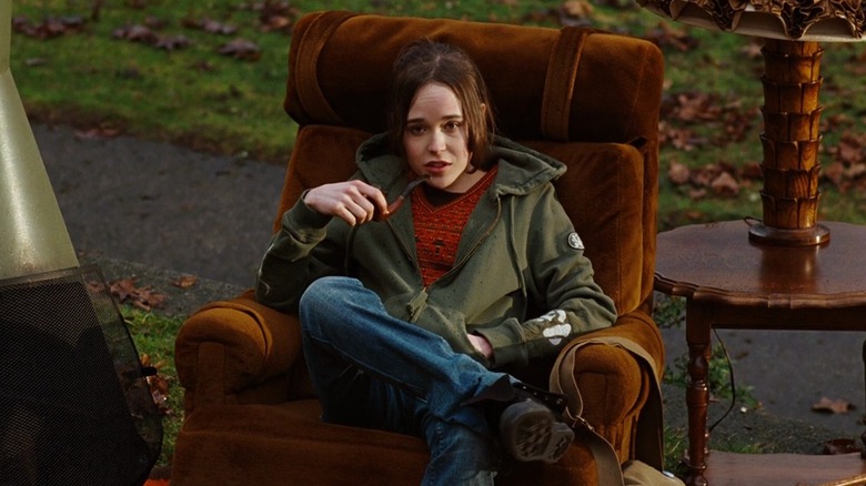 Elliot Page as Juno holding a pipe on a recliner outside in Juno