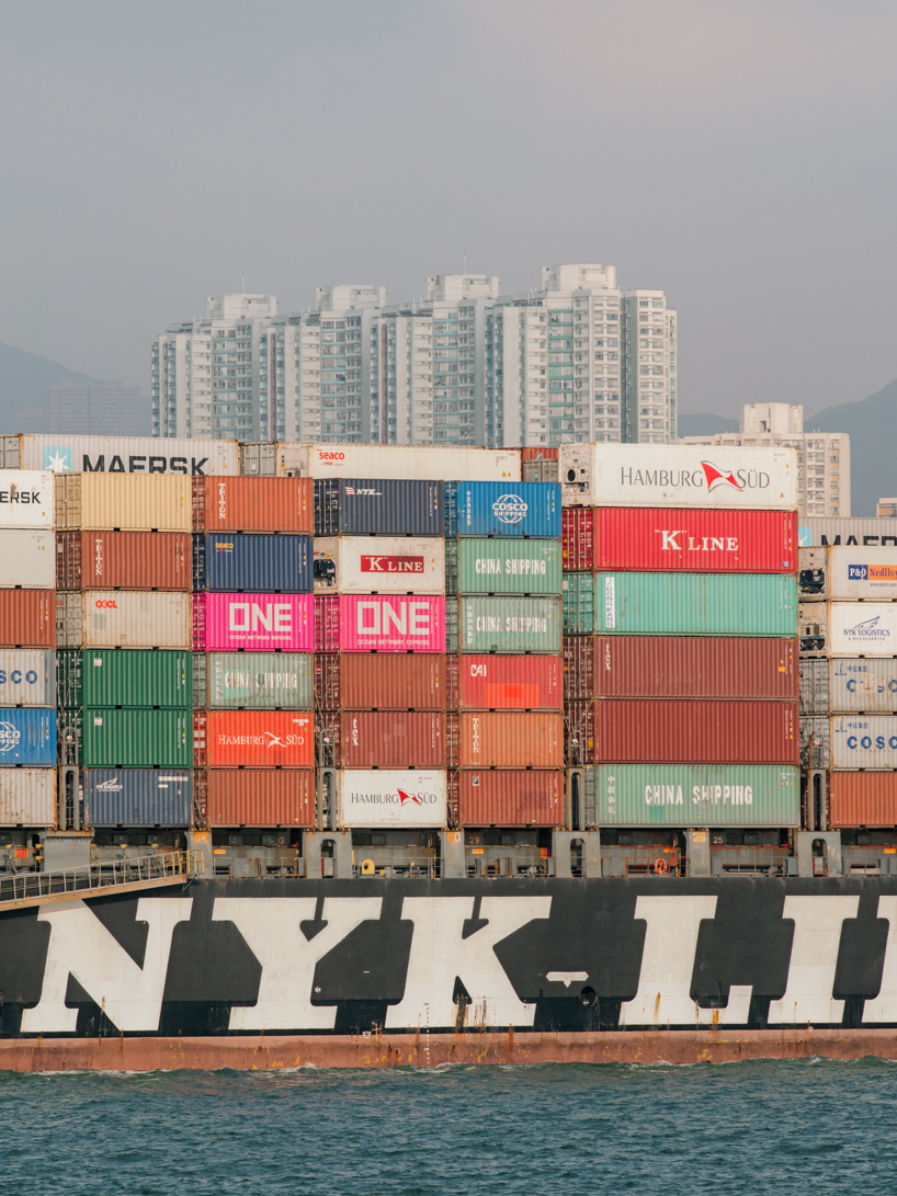 photographer captures cargo ships passing by on his ferry ride home