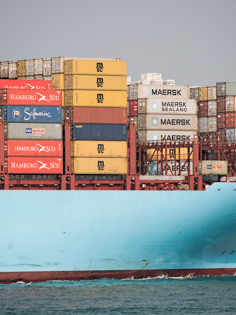 photographer captures cargo ships passing by on his ferry ride home