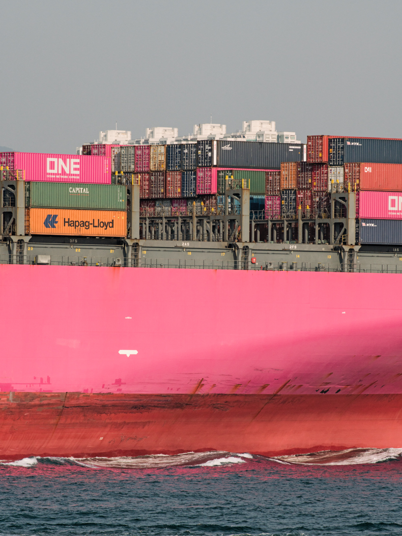 photographer captures cargo ships passing by on his ferry ride home
