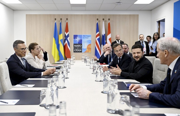 Scandinavian leaders are seen around a table for a NATO meeting with Volodymyr Zelenskyy.