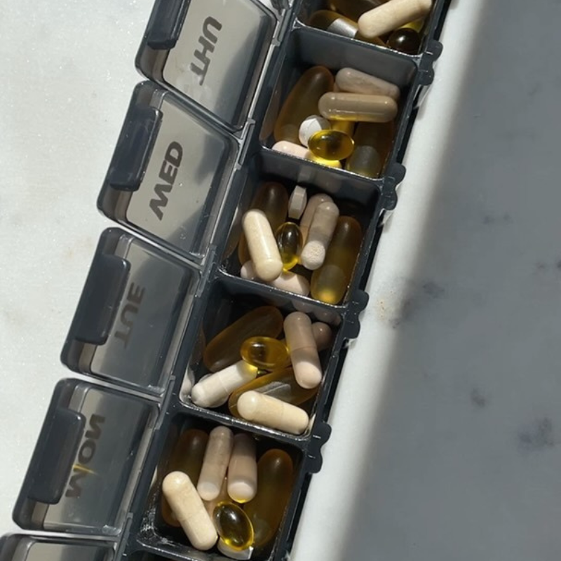 A photo of supplements in a pill box