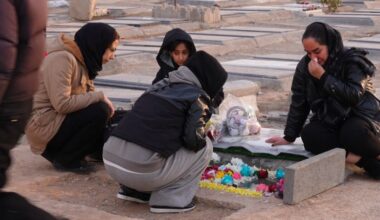Grieving Iranians cowed into silence beside the graves of protesters