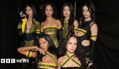 Six-member girl group Katseye in black, yellow and green outfits at the Grammy Awards.