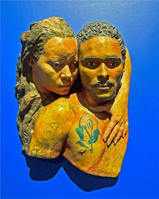 A sculpture of two people embracing by John Ahearn with Rigoberto Torres