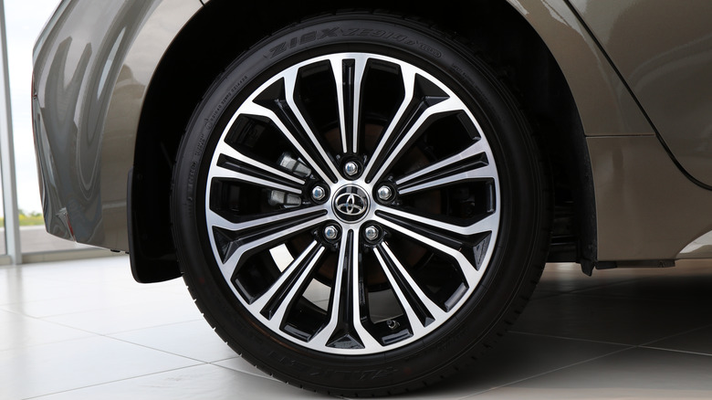 A close-up of a Toyota crossover wearing a Falken tire on its front left corner.
