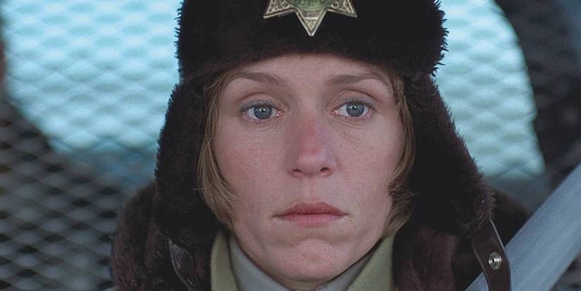 Marge Gunderson, sitting in a cop car and looking sad in Fargo