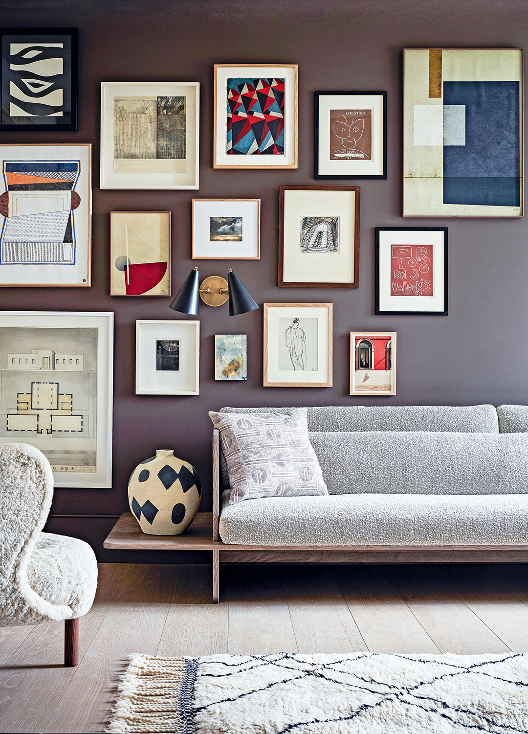 brown living room wall with a picture gallery of assorted artwork