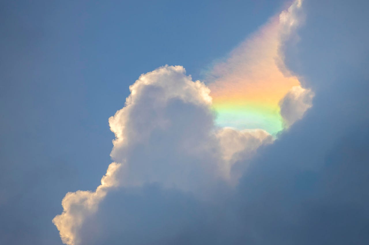 Iridescent clouds formed between cumulus cloud in late afternoon in eastern side of Singapore.