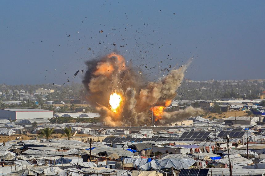 Smoke and fire rises from a shelter housing displaced Palestinians, after an Israeli air strike in the west of Khan Younis on Saturday.