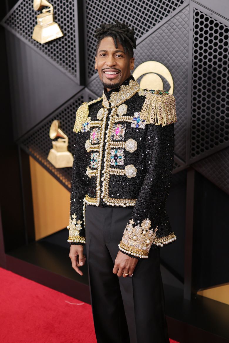 Jon Batiste in a garish embellished military jacket.