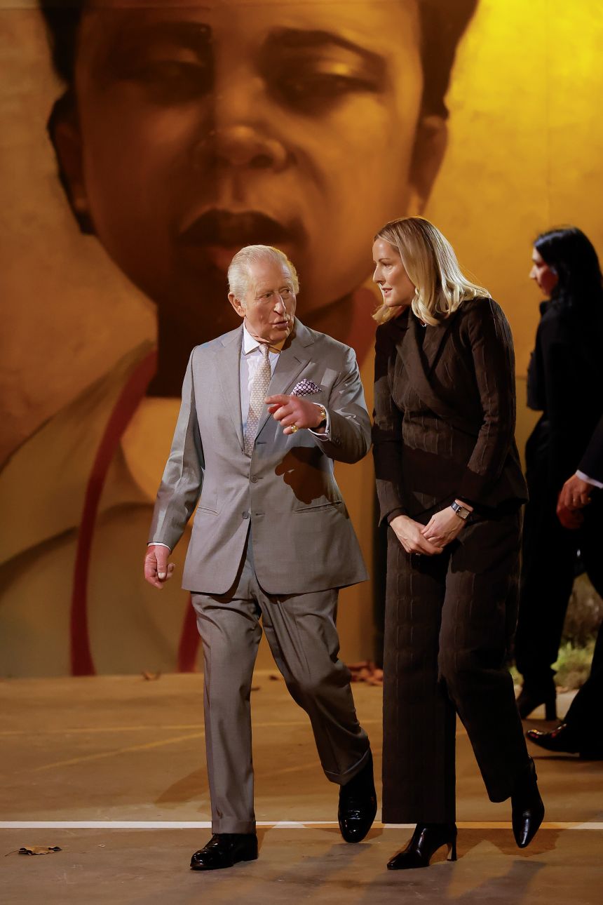 King Charles III is escorted to his seat by British Fashion Council CEO Laura Weir. The show took place at 180 Strand in London.