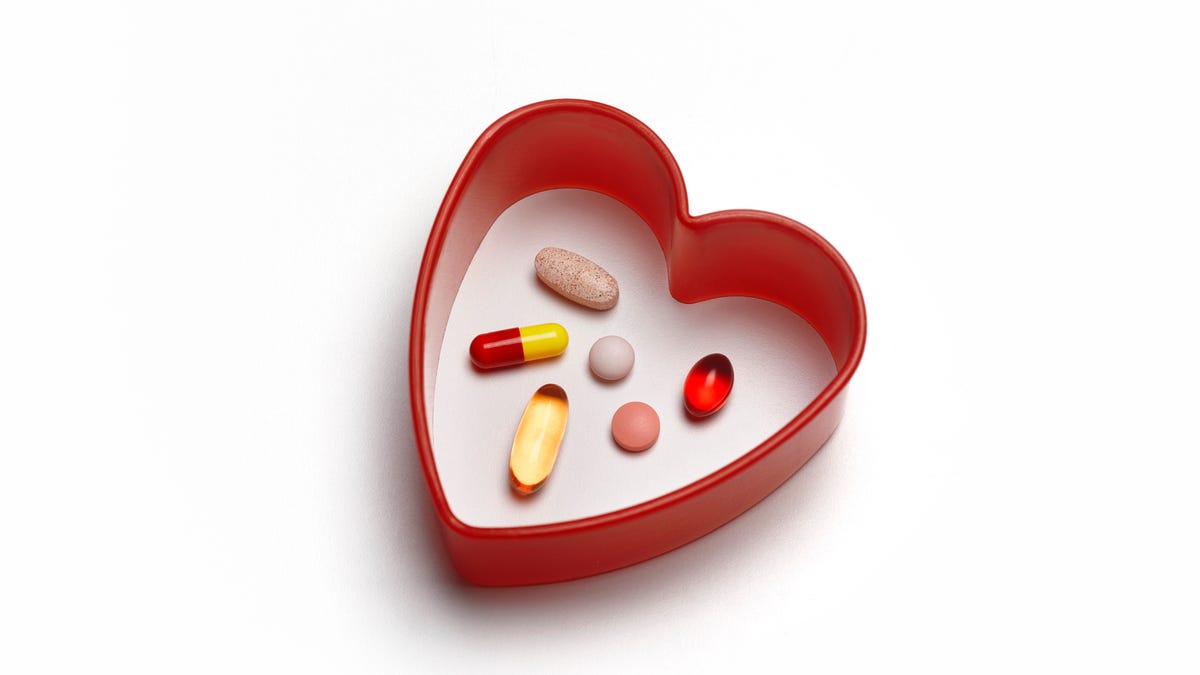 Red heart pill box with six vitamins inside