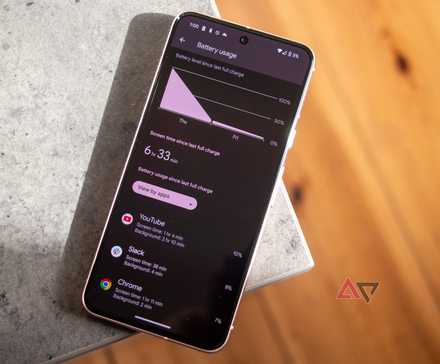 A Pixel 8 with battery app open resting on edge of grey table
