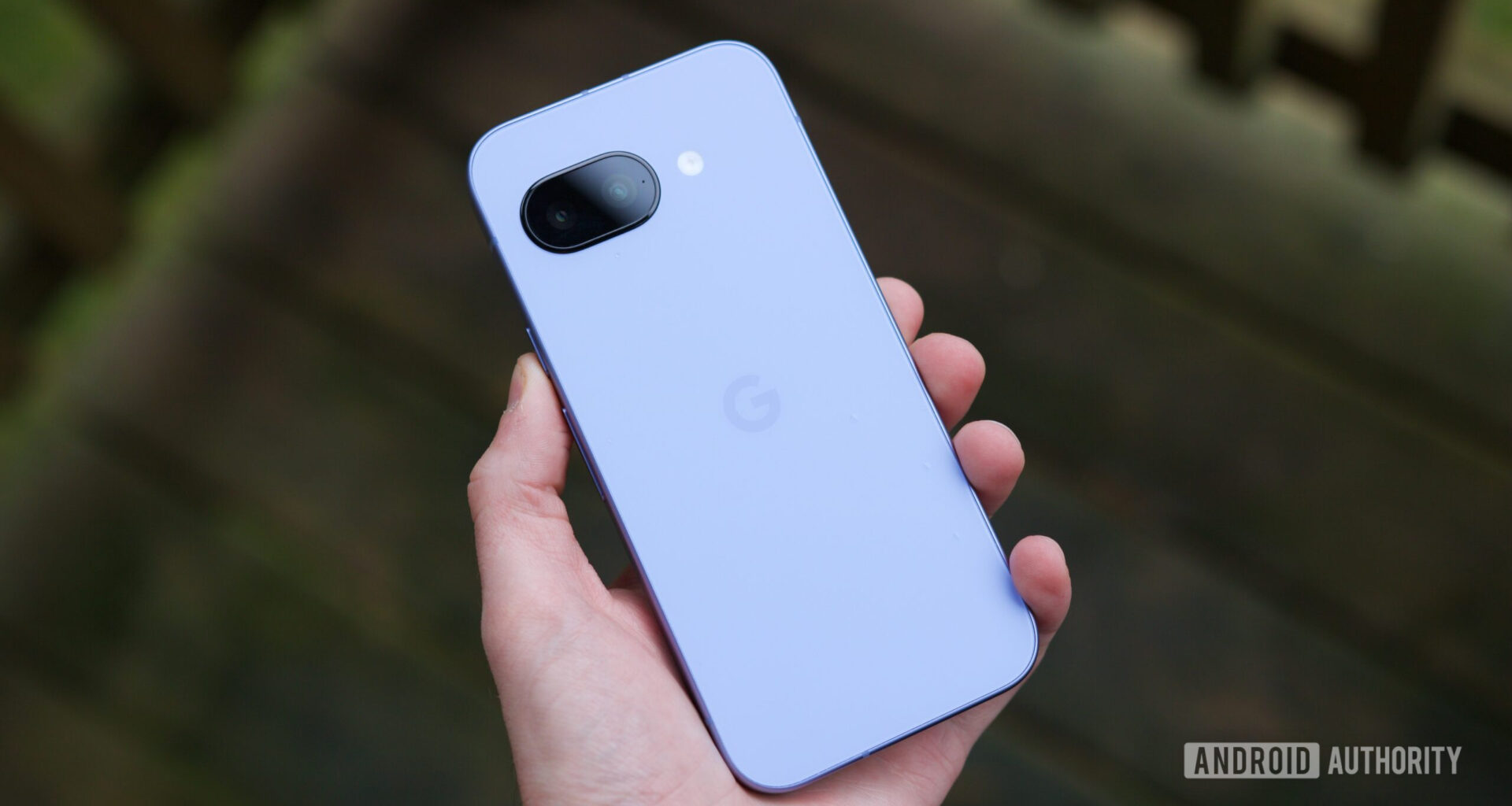 Someone holding the Pixel 9a, showing the back of the phone.