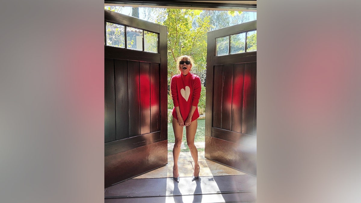 Halle Berry smiled at the camera as she paired her sweater with black sunglasses and heels.