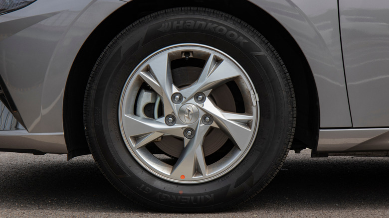 A close-up of a Hyundai SUV wearing a Hankook tire on its front left corner.
